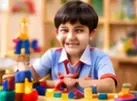 Young student exploring colourful building blocks