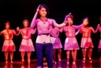 Students performing a dance on stage