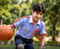 Student playing basketball outdoors